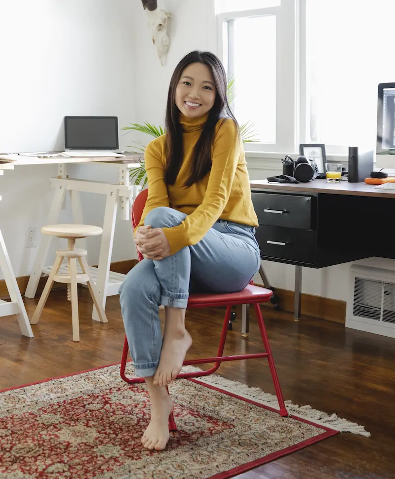 Woman seating in a chair smiling at the camera